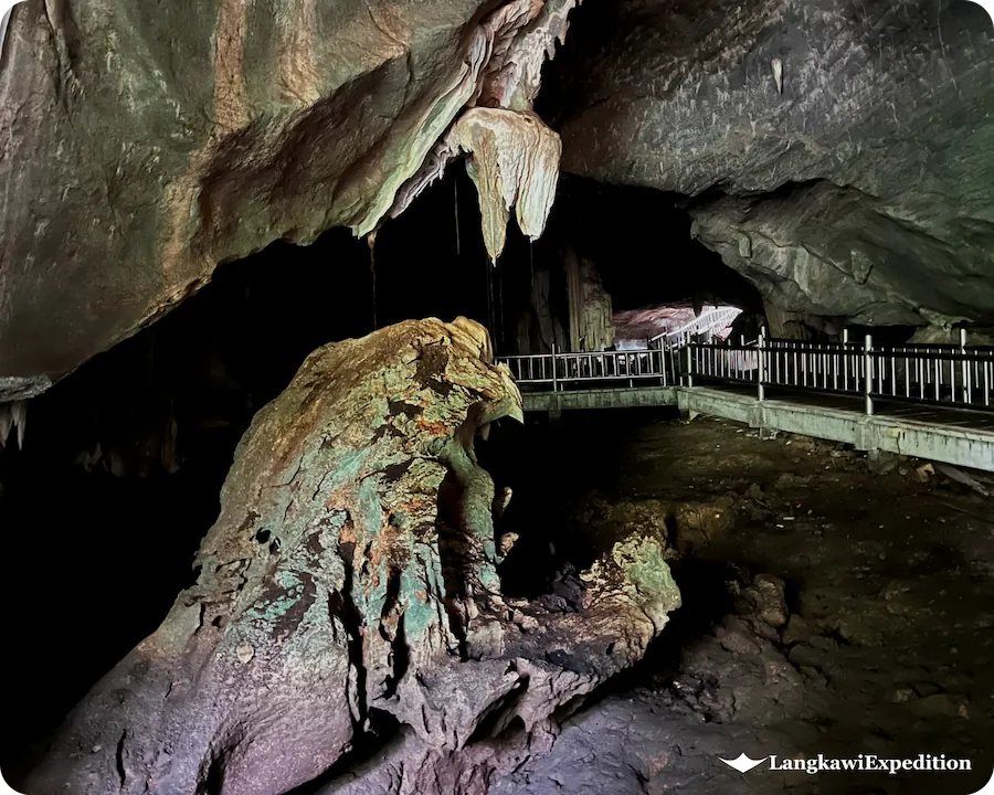 Ancient stalactites and tourist walkway footbridge inside Bat Cave Langkawi