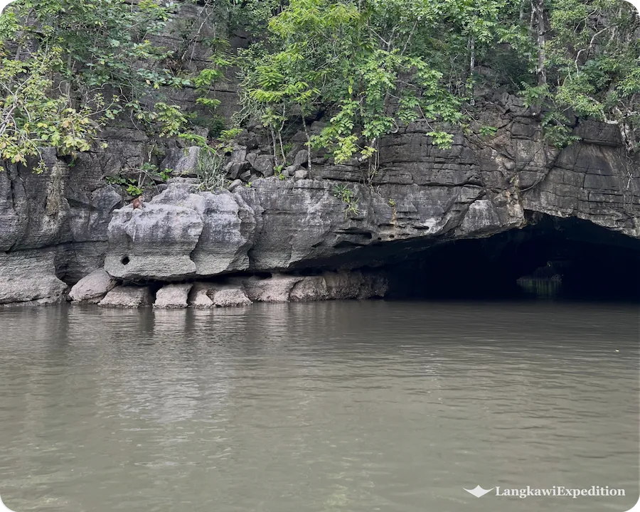 Low-angle view of the natural limestone entrance at Crocodile Cave Kilim