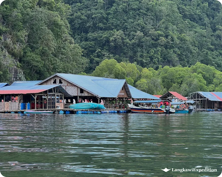 Traditional floating fish farm and aquaculture restaurant platform on Kilim River