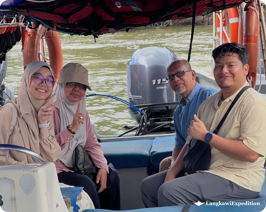Cheerful family travelers enjoying a private mangrove boat charter in Langkawi